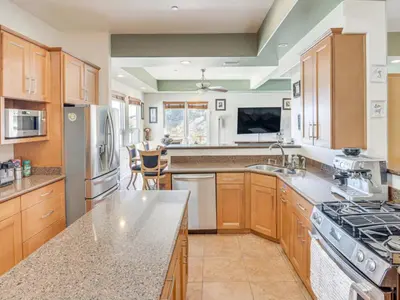 a kitchen with wooden cabinets and a counter top at 3BR Mountain Retreat with 2 Executive Suites & Scenic Views Sleeps 6 in Newbury Park
