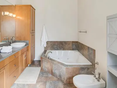 a bathroom with a tub and a toilet and a sink at 3BR Mountain Retreat with 2 Executive Suites & Scenic Views Sleeps 6 in Newbury Park