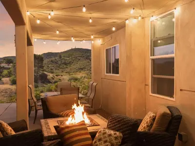 a screened porch with a fire pit and a view at The Surf Retreat in Newbury Park