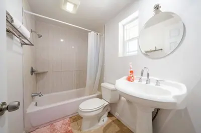 a white bathroom with a sink and a toilet and a tub at 22ppl Garage Parking Btw Disney Hollywood Monterey Park Chinatown in Monterey Park