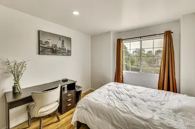 a bedroom with a desk and a bed and a window at 2 Mi to Victoria Gardens Rancho Cucamonga Haven in Rancho Cucamonga