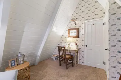 an attic room with a desk and a door at Rocky Point Paradise Bay Lake Front Hot TUB 10 out of 10 in Lake Arrowhead