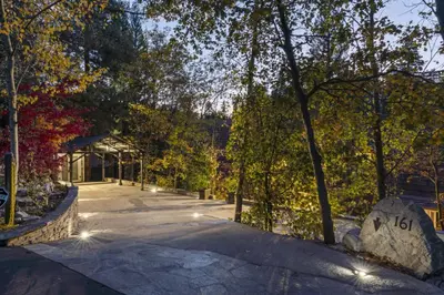 a walkway in a park with trees and lights at Rocky Point Paradise Bay Lake Front Hot TUB 10 out of 10 in Lake Arrowhead