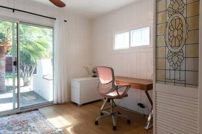 a office with a chair and a desk and a window at 1970s Style Cozy Home with Fireplace Yard and Hot Tub in Inglewood