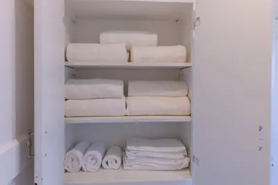 a closet filled with towels and towels at 1970s Style Cozy Home with Fireplace Yard and Hot Tub in Inglewood