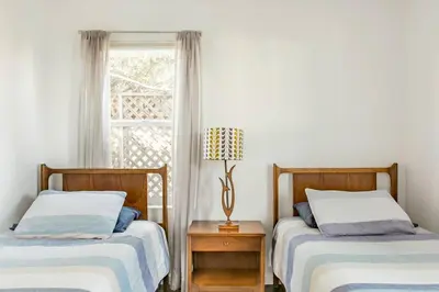 two beds in a room with a window at Perfect Venice Beach Vacation Home for Couples and Families in Los Angeles