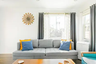 a living room with a couch and a window at Perfect Venice Beach Vacation Home for Couples and Families in Los Angeles
