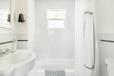 a white bathroom with a tub and a sink at Perfect Venice Beach Vacation Home for Couples and Families in Los Angeles