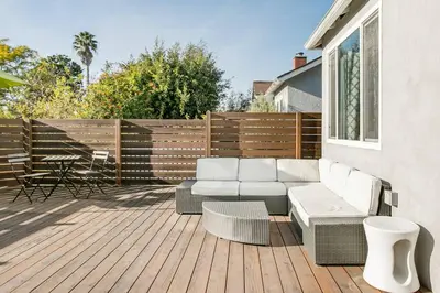 a patio with a couch and chairs on a wooden deck at Perfect Venice Beach Vacation Home for Couples and Families in Los Angeles