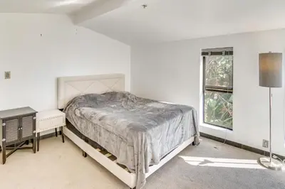 a white bedroom with a bed and a window at 3 Mi to Beach Home with Pool and Spa in Malibu! in Malibu