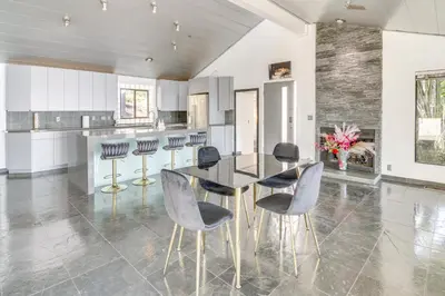 a dining room with a black table and chairs at 3 Mi to Beach Home with Pool and Spa in Malibu! in Malibu