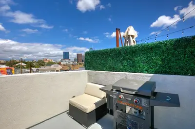 a grill and a chair on a rooftop at La Veranda View Hideaway in Los Angeles