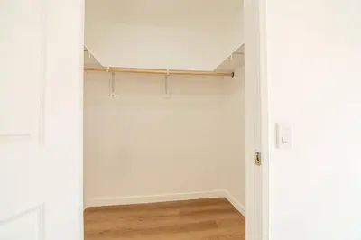 an empty room with white walls and wood floors at 2BR Plus Bonus Room and Pool Access Near Universal Studios in Los Angeles