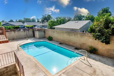a swimming pool in the backyard of a house at 2BR Plus Bonus Room and Pool Access Near Universal Studios in Los Angeles