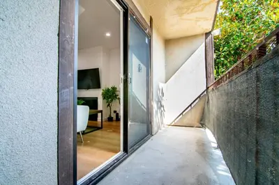 a hallway of a house with sliding glass doors at 2BR Plus Bonus Room and Pool Access Near Universal Studios in Los Angeles