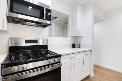 a kitchen with a stove and a microwave at 2BR Plus Bonus Room and Pool Access Near Universal Studios in Los Angeles