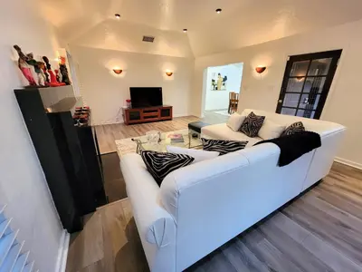 a living room with a white couch and a table at 3 bedroom top story apartment near Pico blvd in Los Angeles