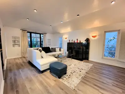 a living room with a white couch and a table at 3 bedroom top story apartment near Pico blvd in Los Angeles