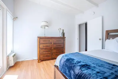 a bedroom with a bed and a wooden dresser at Sunset Hilltop Flat in Los Angeles