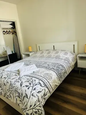 a bedroom with a bed with a white and black comforter at Loft Style,2 Beds ,Flexible self check in,Pool in Marina del Rey