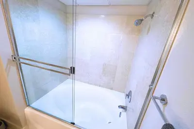 a shower with a glass door in a bathroom at Cozy Apartment Homes On Wilshire Corridor in Los Angeles