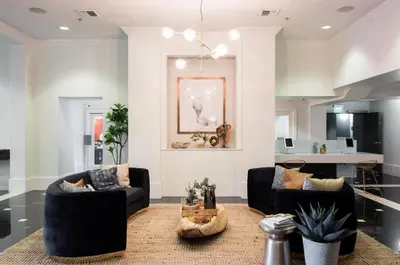 a living room with two couches and a kitchen at Cozy Apartment Homes On Wilshire Corridor in Los Angeles