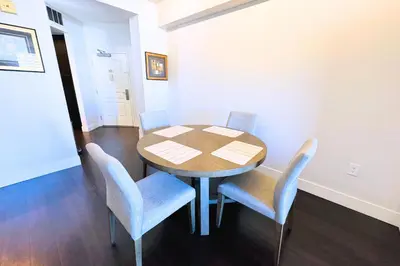 a dining room with a table and blue chairs at Cozy Apartment Homes On Wilshire Corridor in Los Angeles