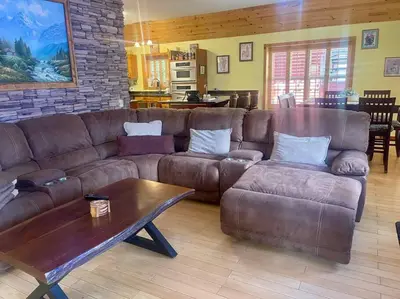a living room with a brown couch and a coffee table at Cabin 7 sleeps 8 BEAUTIFUL BOULDER BAY, BIG BEAR in Big Bear Lake