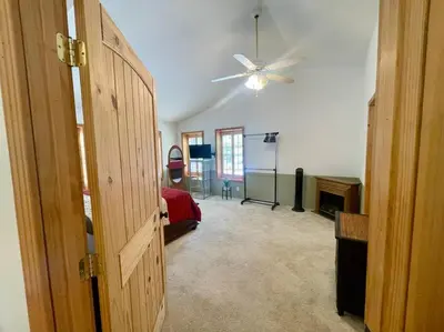 a room with a bedroom with a ceiling fan at Cabin 7 sleeps 8 BEAUTIFUL BOULDER BAY, BIG BEAR in Big Bear Lake