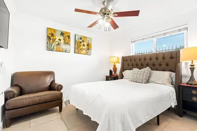 a bedroom with a bed and a chair at Gated 6beds 2garage home near Disney other LA attraction in Chino