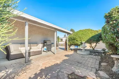 a patio with a couch and a grill at Gated 6beds 2garage home near Disney other LA attraction in Chino