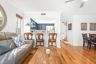 a living room with a couch and chairs and a kitchen at 5bed 3bath Private gated community home 7miles to Downtown La close to Disney in Commerce