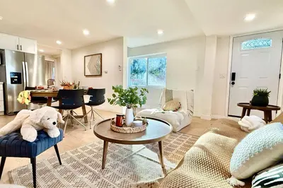 a living room with a teddy bear sitting on a couch at Jies choice Contemporary Elegance in Altadena in Altadena