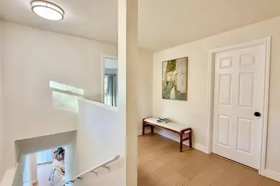 a hallway with a white door and a bench at Jies choice Contemporary Elegance in Altadena in Altadena