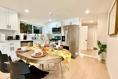 a kitchen with a wooden table with food on it at Jies choice Contemporary Elegance in Altadena in Altadena