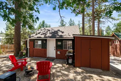 a small cabin with red chairs in front of it at Little Lux - Hot Tub, Walk to Village & Lake in Big Bear Lake
