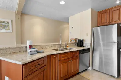 a kitchen with a sink and a refrigerator at Lakeview Condo - Lakefront Complex, Lake Views, Heated Pool in Big Bear Lake