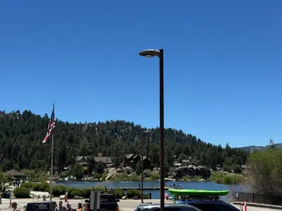 a street light with a car parked in a parking lot at Lakeview Condo - Lakefront Complex, Lake Views, Heated Pool in Big Bear Lake