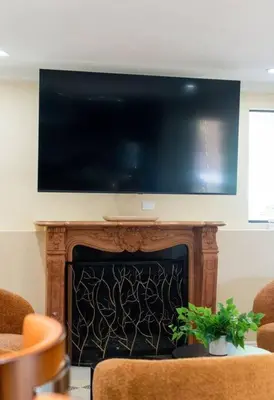 a fireplace with a flat screen tv on top of it at Resort Home with Games, Slide, Oasis in Los Angeles