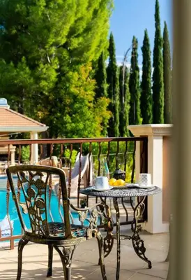a table and a chair with a tray of food on a patio at Resort Home with Games, Slide, Oasis in Los Angeles
