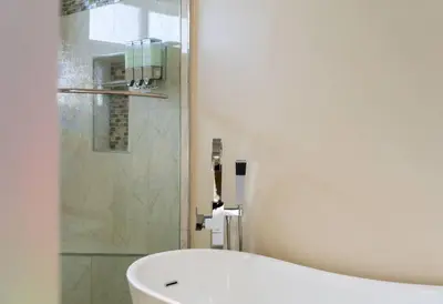 a bathroom with a bath tub and a shower at Resort Home with Games, Slide, Oasis in Los Angeles