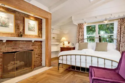 a bedroom with a bed and a fireplace at Villa Encanto- LUXE Spanish Villa with 6 KING Bedrooms, Courtyard and New Game Room in Long Beach