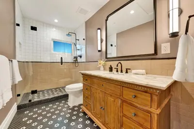 a bathroom with a sink and a toilet and a shower at Villa Encanto- LUXE Spanish Villa with 6 KING Bedrooms, Courtyard and New Game Room in Long Beach