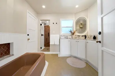 a bathroom with a tub and a sink at Villa Encanto- LUXE Spanish Villa with 6 KING Bedrooms, Courtyard and New Game Room in Long Beach