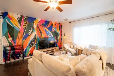 a living room with a couch and a tv at Stylish Cozy, Aesthetic, Stocked Kitchen, and Pet Friendly in Palmdale