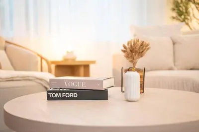 a table with two books and a vase on it at Stylish Cozy, Aesthetic, Stocked Kitchen, and Pet Friendly in Palmdale