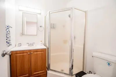 a bathroom with a shower and a sink and a toilet at Stylish Cozy, Aesthetic, Stocked Kitchen, and Pet Friendly in Palmdale