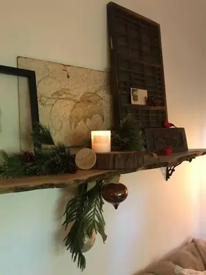 a shelf on a wall with christmas decorations and a mirror at Beautifully Restored Pasadena English Cottage in Pasadena