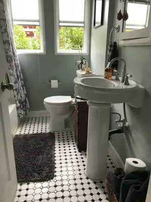 a bathroom with a sink and a toilet at Beautifully Restored Pasadena English Cottage in Pasadena