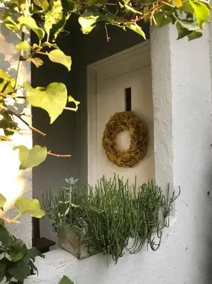 a wreath on the side of a door with plants at Beautifully Restored Pasadena English Cottage in Pasadena